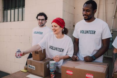 Volunteers in matching shirts sorting boxes of donated aid supplies